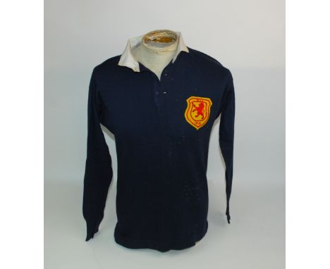 A BLUE SCOTLAND V. ENGLAND INTERNATIONAL SHIRT, 1912 with button-up collar and embroidered cloth badge, inscribed SvE, 1912 W