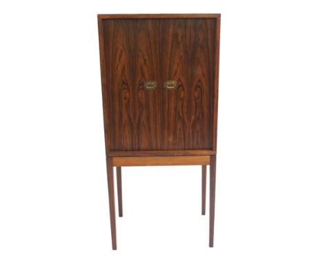 A HENNING KORCH DANISH ROSEWOOD TWO DOOR CABINET ON STAND with two small internal drawers and fitted for pipes, 99cm high x 4