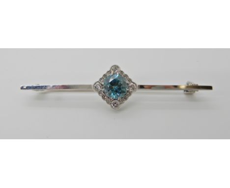 AN 18CT WHITE GOLD DIAMOND AND BLUE ZIRCON BROOCH diamond content approx 0.50cts, dimensions 5.8cm x 1cm, weight approx 5gms 