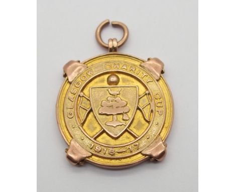 A 9CT GOLD 1916-17 GLASGOW CHARITY CUP WINNERS MEDAL the obverse inscribed Glasgow Charity Cup 1916-17, the reverse inscribed