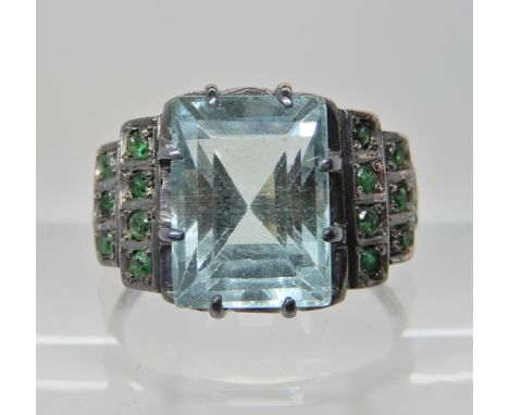 A WHITE METAL DRESS RING SET WITH AQUAMARINE AND EMERALDS aquamarine approx 10.9mm x 8.1mm x 7.2mm, finger size R1/2, weight 