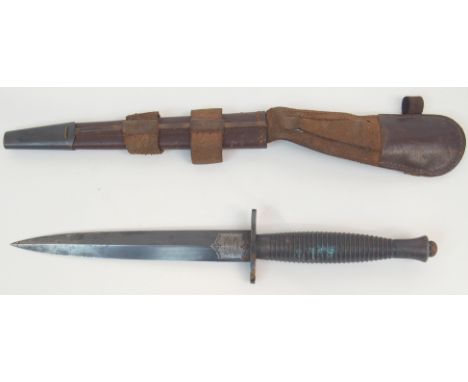 A FAIRBAIRN-SYKES FIGHTING KNIFE with ribbed hilt, the double edged blade marked the F-S Fighting Knife and Wilkinson Sword, 