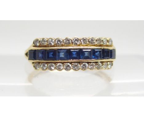 AN 18CT GOLD SAPPHIRE AND DIAMOND LINEAR CLUSTER RING set with 0.22cts of brilliant cut diamonds and square cut sapphires, fi