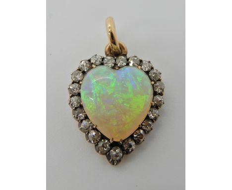 A FIERY WHITE OPAL AND DIAMOND HEART SHAPED PENDANT mounted in yellow and white metal, old cut diamonds estimated approx tota