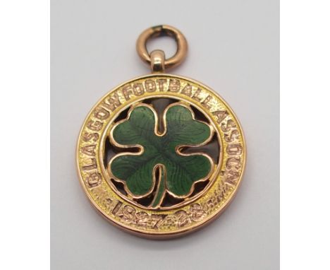 A 9CT GOLD AND ENAMEL GLASGOW FOOTBALL ASSOCIATION WINNERS MEDAL the obverse inscribed Glasgow Football Assocn, 1927-28, the 