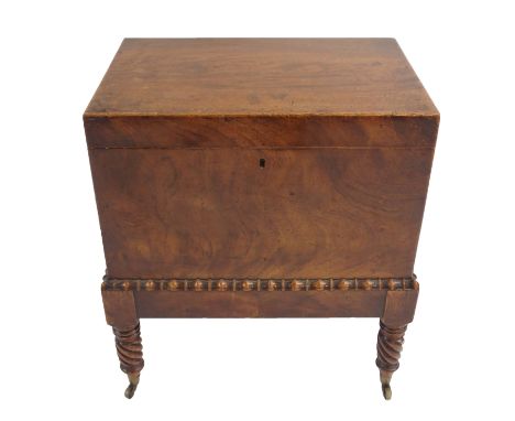 A WILLIAM IV MAHOGANY CELLARETTE the hinged top above brass lion ring mask handles above a faux bamboo band and on spiral tur