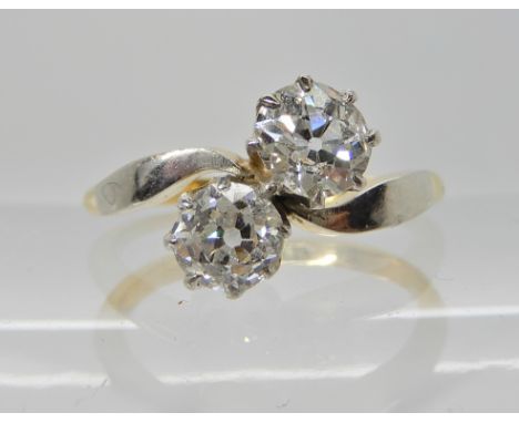 AN 18CT GOLD AND PLATINUM TWIN OLD CUT DIAMOND RING in the classic crown on a twist setting, the diamonds are estimated appro