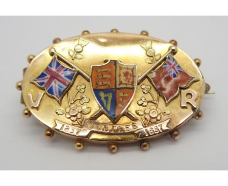 A YELLOW METAL AND ENAMEL BROOCH CELEBRATING VICTORIA'S GOLDEN JUBILEE with flags and shield picked out in enamel, with appli