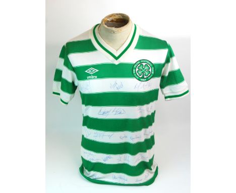 A GREEN AND WHITE CELTIC SHORT-SLEEVED SHIRT with v-neck collar and embroidered cloth badge, the front bearing numerous playe