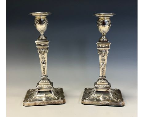 A pair of Edwardian Adam Revival silver candlesticks, embossed in the Neo-Classical taste, 21cm high, William Hutton &amp; So