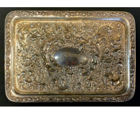 An Edwardian silver repoussé trinket tray, decorated with scrolls, flowers and foliage, S G Jacobs, Birmingham 1903, 21cm x 2