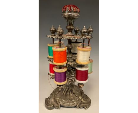 Sewing - a 19th century Rococo Revival silver plated two-tier revolving cotton reel stand, pin cushion cresting, the shaped p