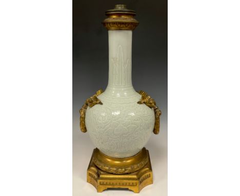 A 19th century Chinese Celadon and Ormolu mounted table lamp base, all over scrolling leaf and vine decoration, tied ribbon a