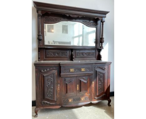 A Victorian Arts and Crafts period mirror-back walnut sideboard, out-swept cornice, above a serpentine shaped mirror, turned 