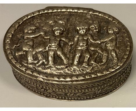 A late 19th century oval snuff box, embossed with cavorting Cherubs, unmarked white metal, 5.6cm x 4.1cm. 