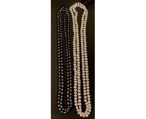 A long single strand cultured black pearl necklace, irregular deep tone black pearls, ranging between approx 6mm to 8mm diame