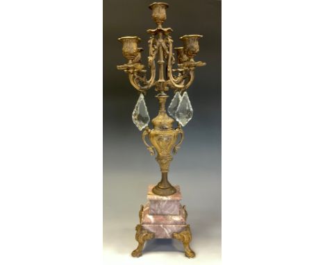 A Louis XV style gilt metal and glass table candelabrum, central sconce, with in four light surround, pale rouge marble base,