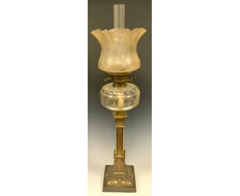 A Victorian brass oil lamp, ornate rounded and reeded column, floral capitol, embossed stepped square base with tied ribbon a