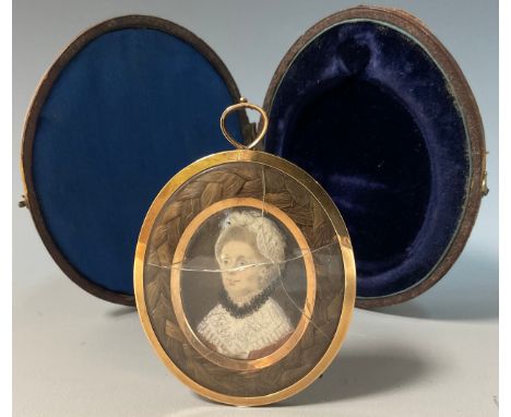 A 19th century oval portrait miniature mourning pendant, central panel of a lady, within hairwork plait, the reverse initiall