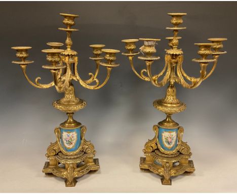 A pair of 19th century French porcelain mounted gilt metal six-light candelabra, cast in the Louis XVI manner and painted in 