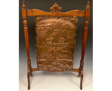 An Arts and Crafts oak and planished copper fire-screen, 90cm high x 58cm wide. 