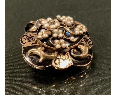 A Victorian diamond and seed pearl mourning brooch, the lobed double layered black and gold body with rose cut diamond and th