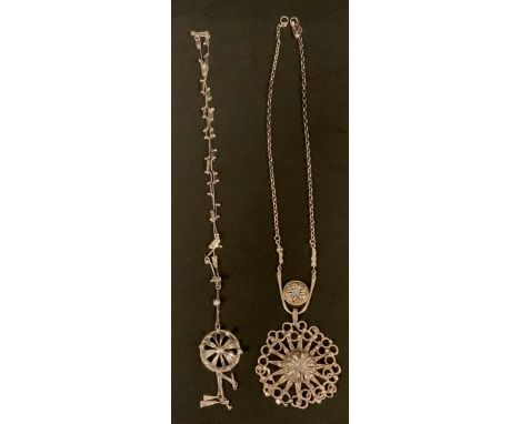 A sterling silver hand crafted pendant necklace, set with two opaline cabochons within many pointed star and ring frame, susp