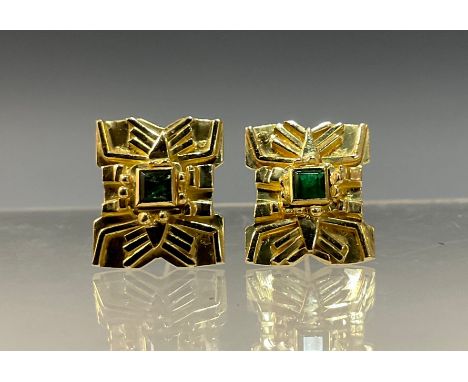 A pair of emerald earrings, each Aztec style shield mount centred with a single square cut emerald, total estimated emerald w