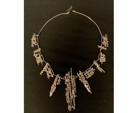 A Brutalist inspired hand crafted silver necklace, composed of thirteen individual unique block, ball and wire sections, curv