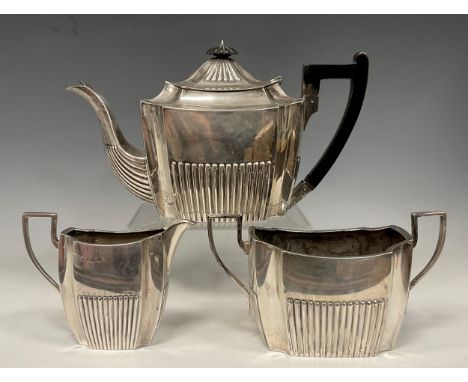 A Victorian silver three piece tea set,  ebony handled teapot, sugar bowl and milk jug, Martin, Hall &amp; Co (Richard Martin