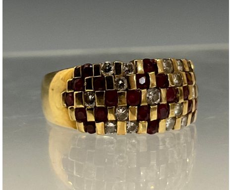 A diamond and ruby chequer panel ring, set with fifteen round brilliant cut diamonds and twenty four pinky red rubies, total 