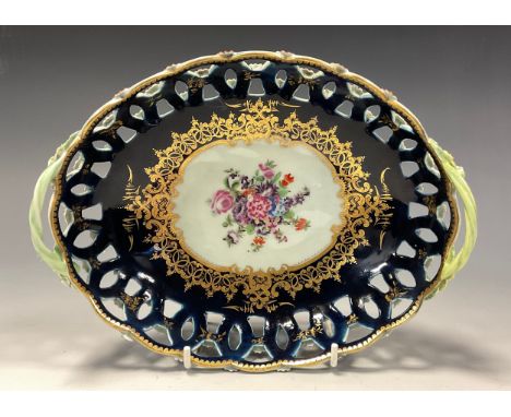An 18th century Worcester porcelain twin handle oval basket, pierced sides, painted with flowers, rich gilt elaborate floral 