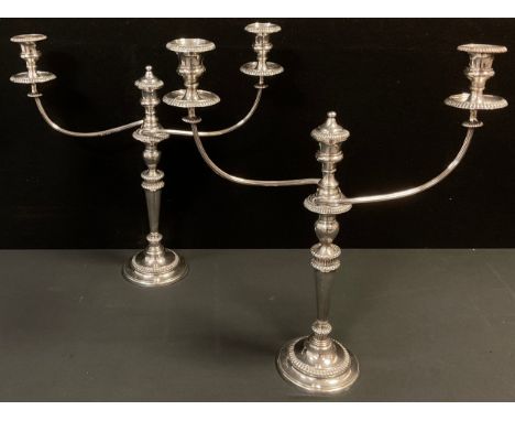 A pair of George III Old Sheffield Plate three-light table candelabra, campana sconces with detachable nozzles, gadrooned bor
