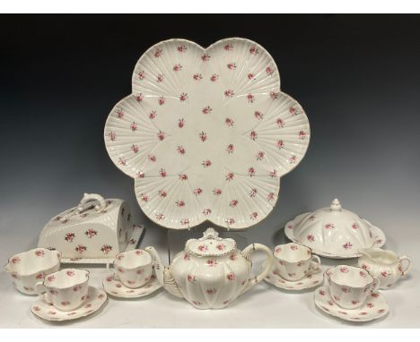 A Wileman and Co cabaret service for four, pattern 'Springs of roses' no. 7447 comprised of; four dainty-shaped tea cups and 