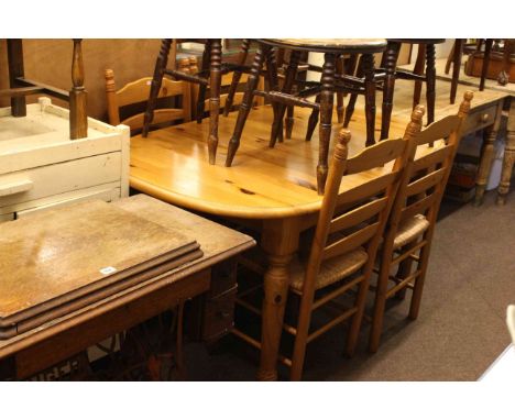 Oval pine extending dining table and four rush seated ladder back chairs