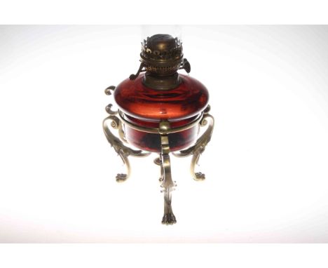 Ornate brass three paw foot oil lamp with coloured glass reservoir