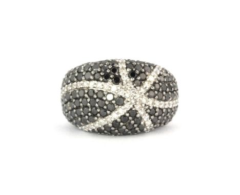 An 18ct white gold black and white diamond cluster ring, approx. 1.50ct, (O)