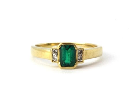 An 18ct yellow gold (stamped 18ct) emerald and diamond set ring, (L.5).&nbsp;Weight - 2.9g.