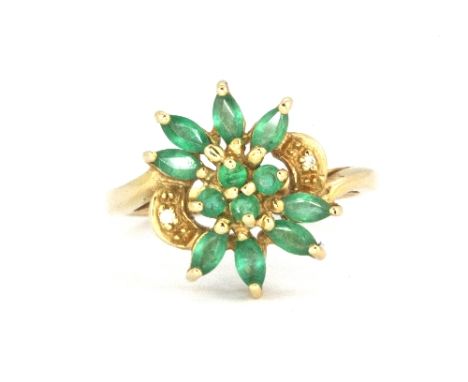 A 9ct yellow gold emerald and diamond set cluster ring, (N).&nbsp;Weight - 3.5g.