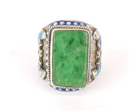 A Chinese enamelled white metal (tested silver) jade set gentleman's ring with symbol of a bat on each side. Ring size adjust