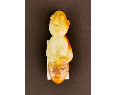 An interesting Chinese carved celadon and russet jade amulet with a human head and arms and an insect body,  H. 6.5 cm.