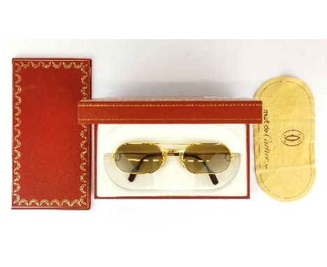A pair of Must de Cartier vintage sunglasses with original guarantee and box.