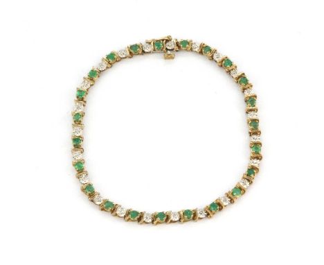 A9ct yellow gold diamond and emerald set line bracelet, L. 20cm.