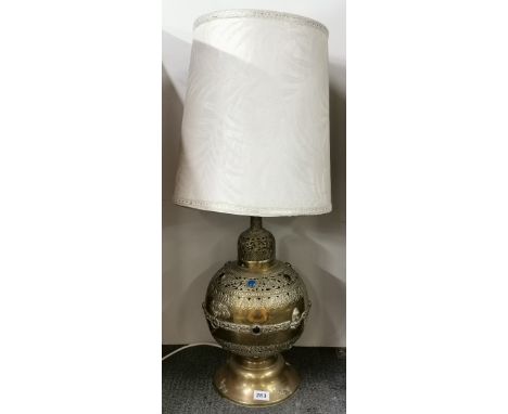 An eastern hammered brass jewelled floor lamp, Height with shade 89cm.