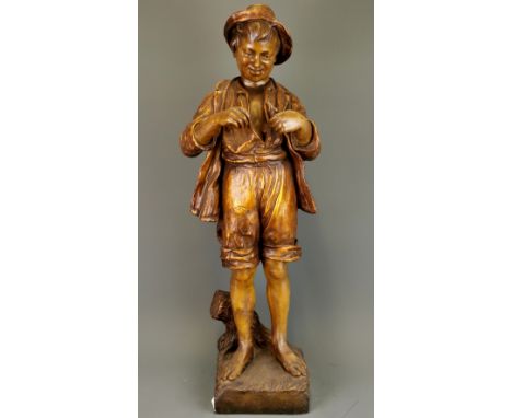 A large 19th Century ceramic figure of a boy fishing. H. 75cm.  Repair to neck and feet.