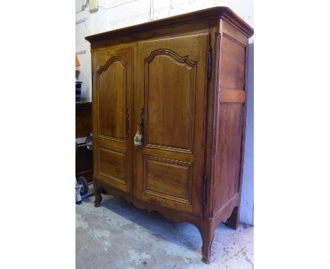 ARMOIRE, late 18th/early 19th century French cherrywood and chestnut with two panelled doors enclosing a shelf and a shaped a