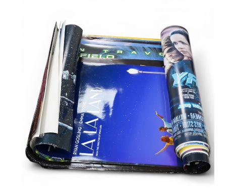 A large quantity of various movie posters including La La Land, Battlefield Earth, Broken Arrow, etc.