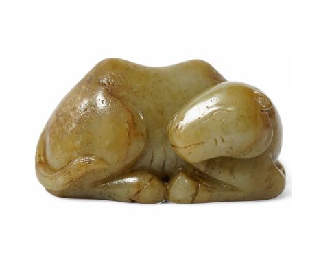 A Chinese carved jade figure of a recumbent Bactrian camel, 7.5cm long. Condition - good