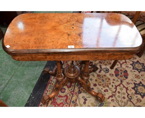 A Victorian walnut and marquetry card table, rounded rectangular top inlaid with flowerheads, bell husks and scrolling foliag