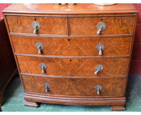 An early 20th century walnut and mahogany bow front chest of two short over three long drawers, substantial drop handles, scr